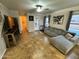 Bright living room with tile floors and grey sectional couch at 8504 E Lindner Ave, Mesa, AZ 85209