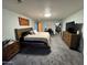 Spacious bedroom with a king bed, wood dresser, and walk-in closet at 8504 E Lindner Ave, Mesa, AZ 85209