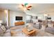 Open-concept living room with comfortable seating, ceiling fan, and hardwood floors. Includes a view to the kitchen and dining area at 900 S 94Th St # 1204, Chandler, AZ 85224
