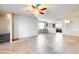 Spacious, light-filled open-concept living room features tile floors and a ceiling fan. View into kitchen with counter seating at 900 S 94Th St # 1204, Chandler, AZ 85224