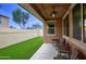 Covered back patio overlooking a grassy yard, perfect for outdoor enjoyment at 9295 W Wood Dr, Peoria, AZ 85381
