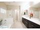 Bright bathroom features a double sink vanity, soaking tub, and separate shower, creating a spa-like retreat at 9295 W Wood Dr, Peoria, AZ 85381