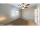 Bright bedroom offers a ceiling fan, plush carpet, and a window with natural light and peaceful neighborhood views at 9295 W Wood Dr, Peoria, AZ 85381
