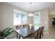 Dining area with natural light, modern lighting, and a wood table with seating for six at 9295 W Wood Dr, Peoria, AZ 85381