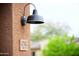 Close-up of house number with modern outdoor lighting fixture and lush landscaping at 9295 W Wood Dr, Peoria, AZ 85381