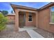 Close up view of home's front door with desert landscaping and welcoming covered entrance at 9295 W Wood Dr, Peoria, AZ 85381