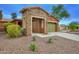 Lovely home with stone-accented entrance, low-maintenance landscaping, and charming curb appeal at 9295 W Wood Dr, Peoria, AZ 85381