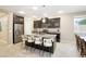 Well-equipped kitchen boasts dark cabinets, stainless steel appliances, and an island with barstool seating at 9295 W Wood Dr, Peoria, AZ 85381
