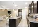 Spacious kitchen featuring dark cabinetry, granite countertops, and an island with bar seating at 9295 W Wood Dr, Peoria, AZ 85381