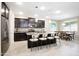 Open kitchen featuring dark cabinetry, stainless steel appliances, and a granite-topped kitchen island at 9295 W Wood Dr, Peoria, AZ 85381