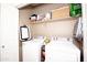Functional laundry room with washer, dryer, and shelving for storage at 9295 W Wood Dr, Peoria, AZ 85381