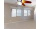 Bright living room showcasing neutral paint, tile floors, and windows overlooking the neighborhood at 9295 W Wood Dr, Peoria, AZ 85381
