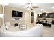 Open living room and kitchen layout with island seating, modern fixtures, and ample cabinet space at 9295 W Wood Dr, Peoria, AZ 85381
