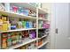 Well-stocked pantry offers ample storage with organized shelves filled with various food items and household goods at 9295 W Wood Dr, Peoria, AZ 85381