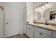 Bathroom featuring a double vanity with granite countertop and two round mirrors at 9451 E Becker Ln # 1041, Scottsdale, AZ 85260