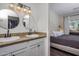 Granite countertop in bathroom with double sinks, round mirrors and a bedroom is visible at 9451 E Becker Ln # 1041, Scottsdale, AZ 85260