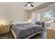 Bedroom with a ceiling fan, dark floors, and a sliding glass door to a balcony at 9451 E Becker Ln # 1041, Scottsdale, AZ 85260
