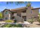 Condominium complex with stucco exterior, tile roof, desert landscaping and exterior stairs to upper level units at 9451 E Becker Ln # 1041, Scottsdale, AZ 85260