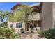 Exterior elevation of building with arched window, balconies and manicured landscaping at 9451 E Becker Ln # 1041, Scottsdale, AZ 85260