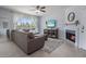 Bright living room with a fireplace, tile flooring, and a large window with views of the exterior at 9451 E Becker Ln # 1041, Scottsdale, AZ 85260