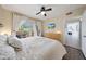 Bright main bedroom featuring a ceiling fan, wood floors, and a television above a wood dresser at 9451 E Becker Ln # 1041, Scottsdale, AZ 85260