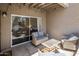 Covered patio with wicker sofas and chairs. Sliding glass door leads to bedroom at 9451 E Becker Ln # 1041, Scottsdale, AZ 85260