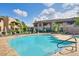 Inviting community pool surrounded by lounge chairs and lush landscaping under a bright sky at 9451 E Becker Ln # 1041, Scottsdale, AZ 85260
