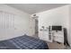 This bedroom features a closet, a TV, and carpeted floors at 9903 N 87Th Dr, Peoria, AZ 85345