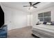 This bedroom features a ceiling fan and a bright window with natural light at 9903 N 87Th Dr, Peoria, AZ 85345