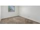 This carpeted bedroom has a bright window with blinds for privacy at 9903 N 87Th Dr, Peoria, AZ 85345