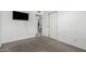 This bedroom features a bright window and a closet with sliding doors at 9903 N 87Th Dr, Peoria, AZ 85345
