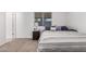 A cozy bedroom featuring a nightstand, window, and comfortable bed with stylish bedding at 9903 N 87Th Dr, Peoria, AZ 85345