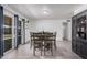 Bright dining area with backyard views, patio access, and modern furniture at 9903 N 87Th Dr, Peoria, AZ 85345