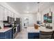 Charming kitchen with stainless steel appliances and bright white and blue cabinetry at 9903 N 87Th Dr, Peoria, AZ 85345