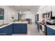 This kitchen features blue cabinets, stainless steel appliances, and an open concept design at 9903 N 87Th Dr, Peoria, AZ 85345