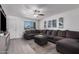 Cozy living room boasts a large sectional, modern decor, and bright, neutral finishes at 9903 N 87Th Dr, Peoria, AZ 85345