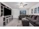Relaxing living room featuring a large television, contemporary furnishings, and an inviting ambiance at 9903 N 87Th Dr, Peoria, AZ 85345