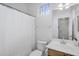 Well-lit bathroom featuring a vanity, toilet, and shower with white curtain at 10132 E Isleta Ave, Mesa, AZ 85209