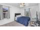 Cozy bedroom with gray carpet, a ceiling fan, and two windows providing natural light at 10132 E Isleta Ave, Mesa, AZ 85209
