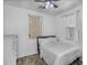 Bright bedroom with wood-look floors, two windows, and a neutral color scheme at 10132 E Isleta Ave, Mesa, AZ 85209