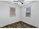 Cozy bedroom with two windows allowing natural light and laminate wood flooring at 10132 E Isleta Ave, Mesa, AZ 85209