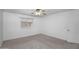 Clean, carpeted bedroom featuring a ceiling fan and a window for natural light at 10132 E Isleta Ave, Mesa, AZ 85209