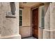 Inviting home entrance featuring a wooden door, house number, and well-maintained stucco exterior at 10132 E Isleta Ave, Mesa, AZ 85209