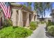 Inviting front exterior showcasing a covered porch, desert landscaping, and a charming American flag at 10132 E Isleta Ave, Mesa, AZ 85209
