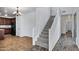 Hallway featuring staircase, tile, wood floors, white paint and an interior door at 10132 E Isleta Ave, Mesa, AZ 85209