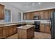 Large kitchen showcasing granite countertops, black appliances and brown cabinets at 10132 E Isleta Ave, Mesa, AZ 85209