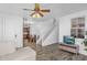 Open living space with wood-look floors, access to the kitchen, and staircase, great for entertaining at 10132 E Isleta Ave, Mesa, AZ 85209