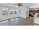 Inviting living room featuring wood floors, a ceiling fan, and bright windows at 10132 E Isleta Ave, Mesa, AZ 85209