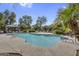 Community pool featuring lush landscaping and ample lounging space under a clear blue sky at 10132 E Isleta Ave, Mesa, AZ 85209