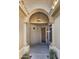 Inviting arched entryway features a wood door, side window, and hanging lantern at 10160 E Conieson Rd, Scottsdale, AZ 85260
